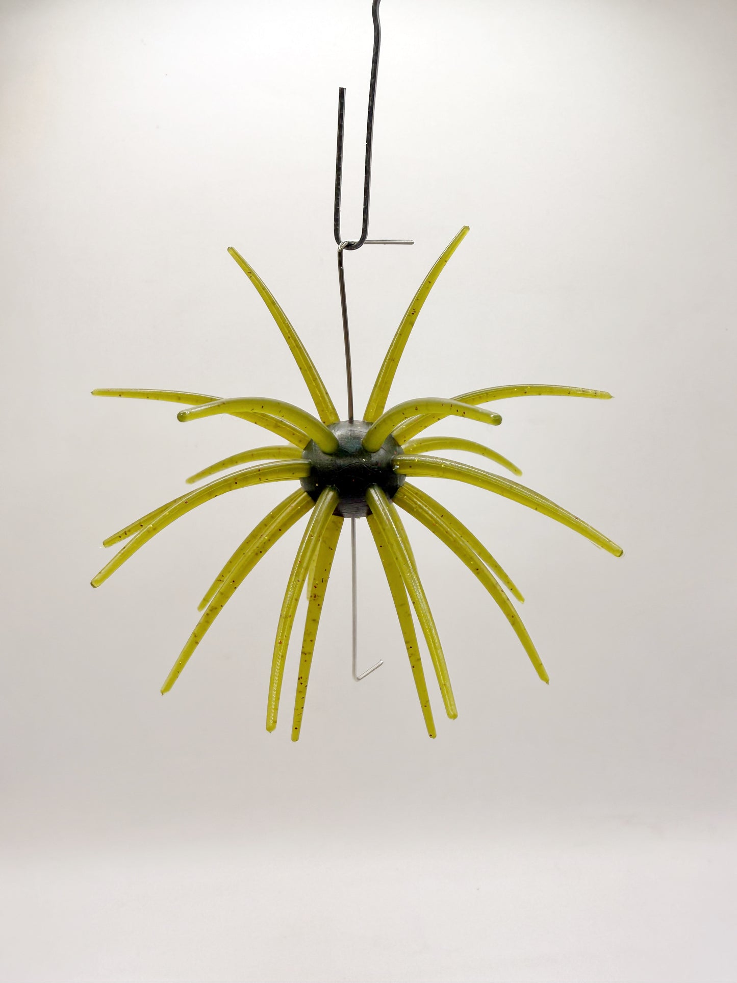 Green urchin lure on a white background