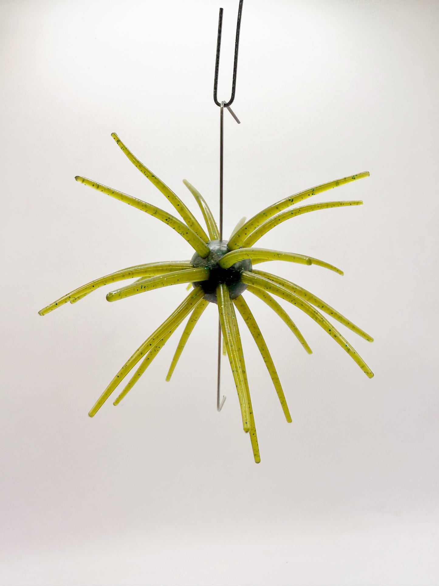 Green urchin lure on a white background