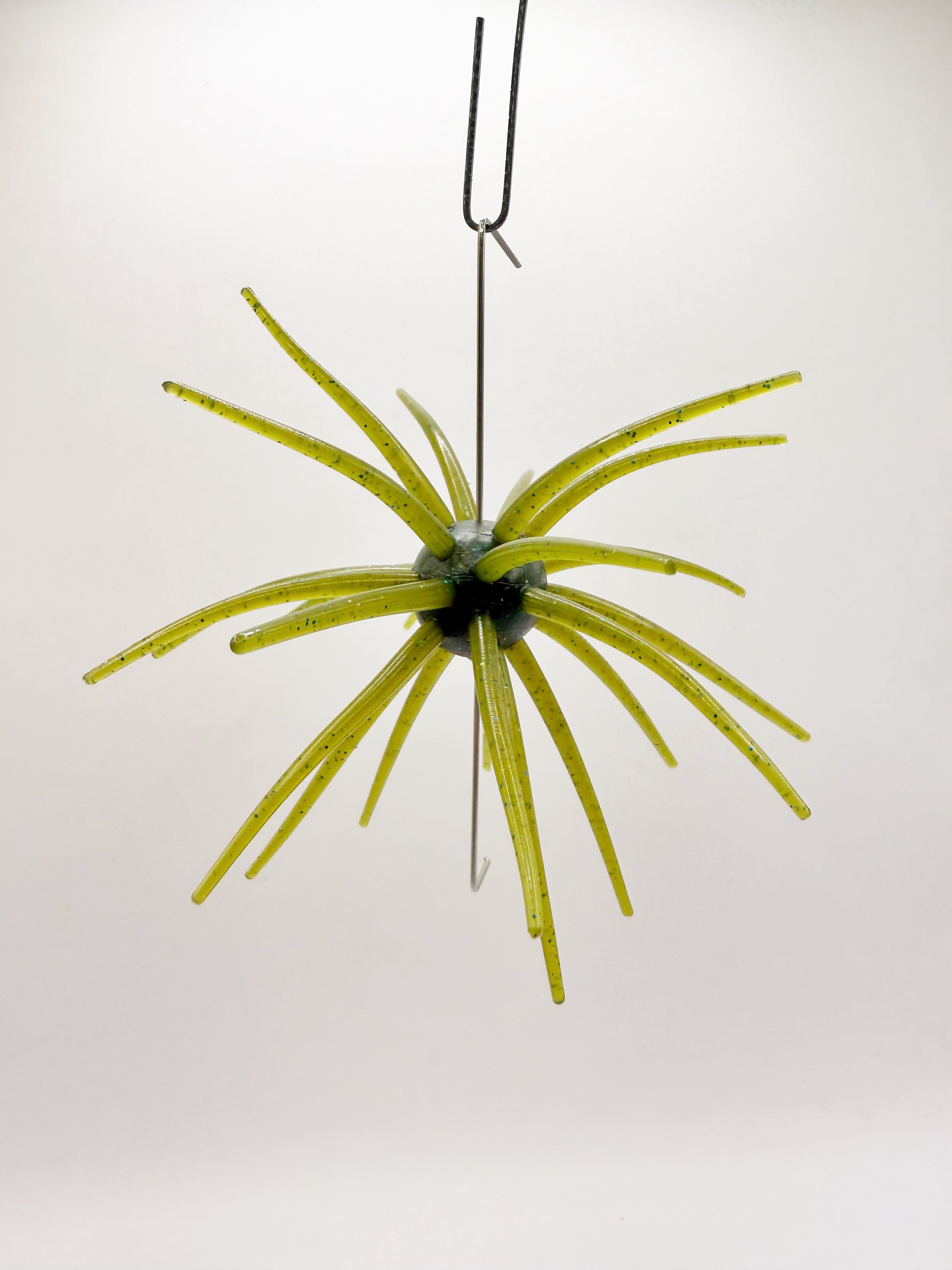 Green urchin lure on a white background