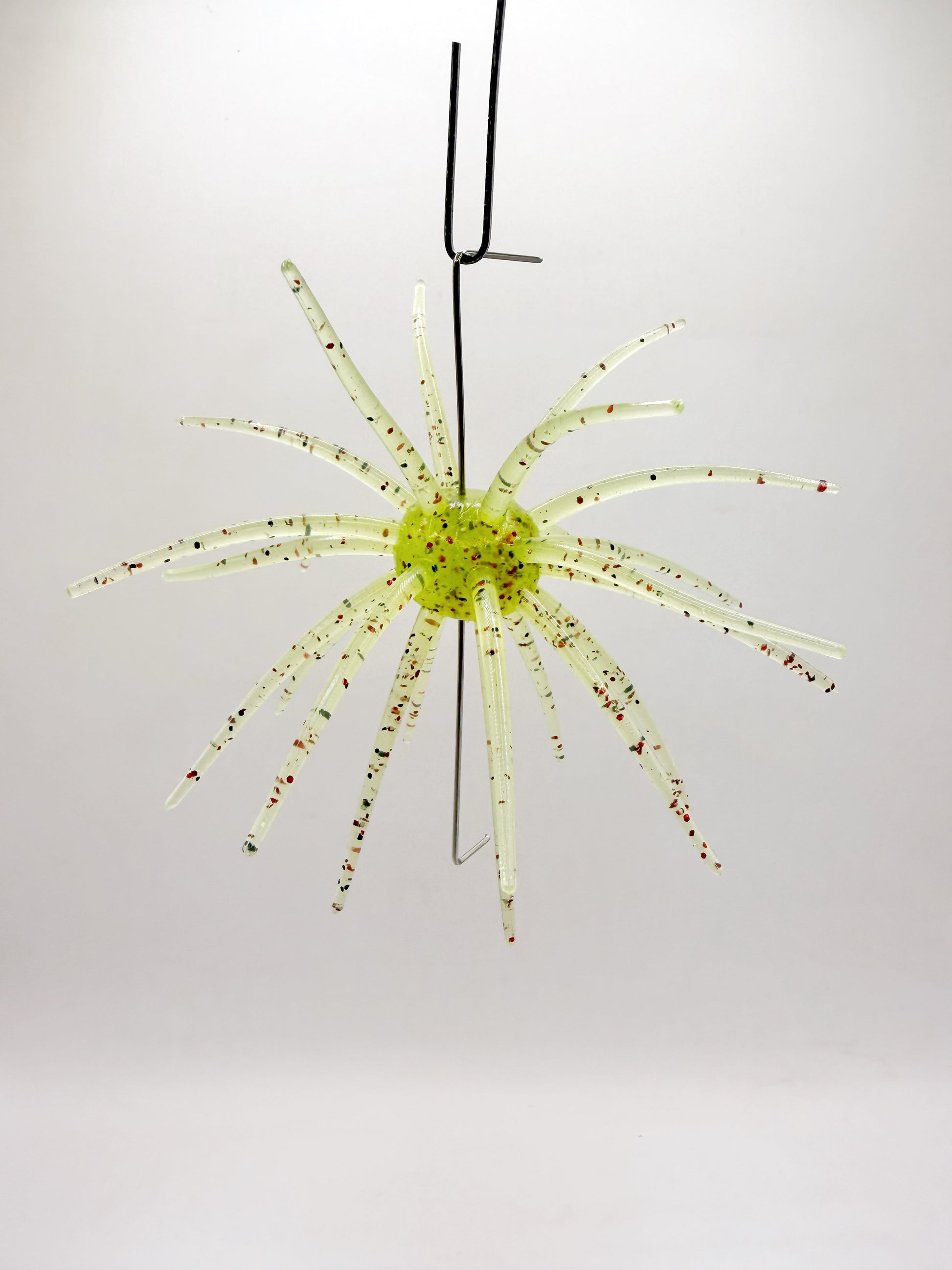 Hanging yellow urchin lure on a white background